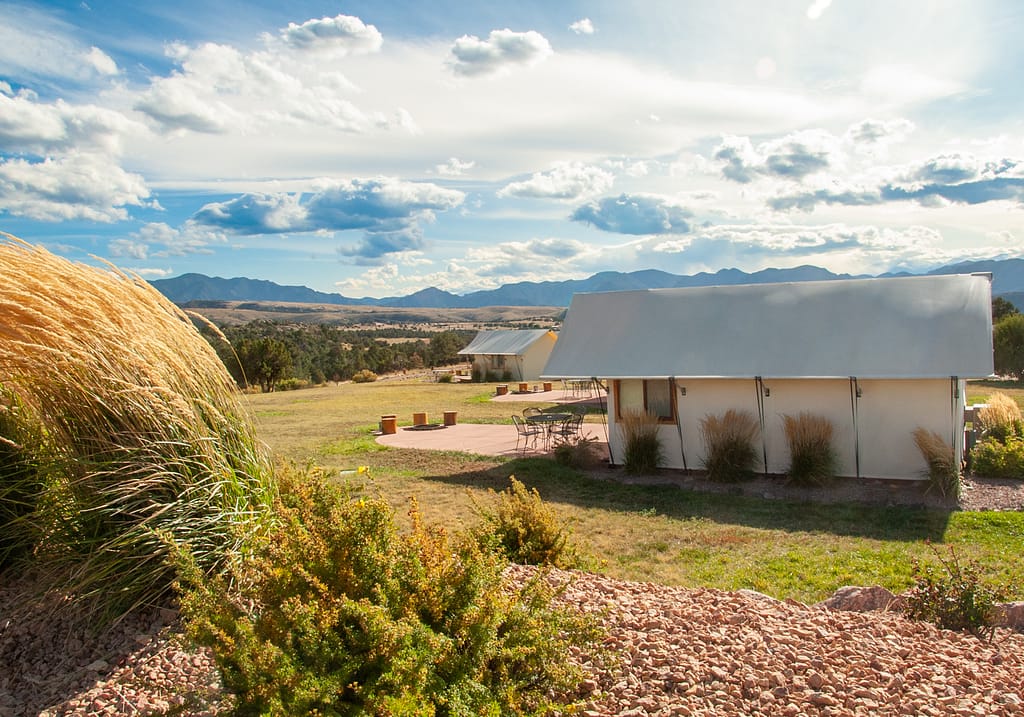 Family enjoying a luxury glamping tent experience at Royal Gorge Cabins in Colorado.