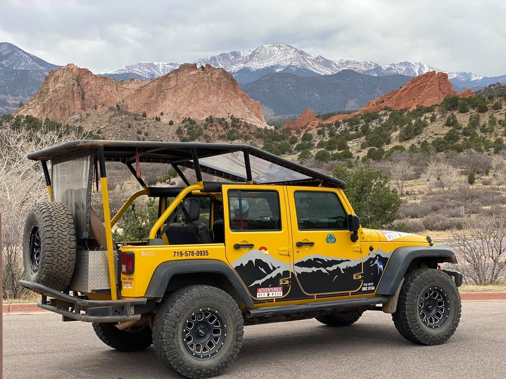 jeep with garden of the gods and pikes peak in background