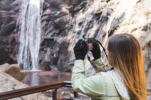 Tourist taking photo at Seven Falls
