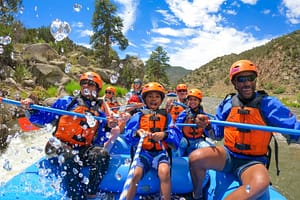 Family getting splashed on raft with Echo Canyon River Expeditions