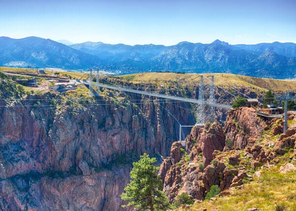 summer time view of Royal Gorge and bridge with mountains in distance