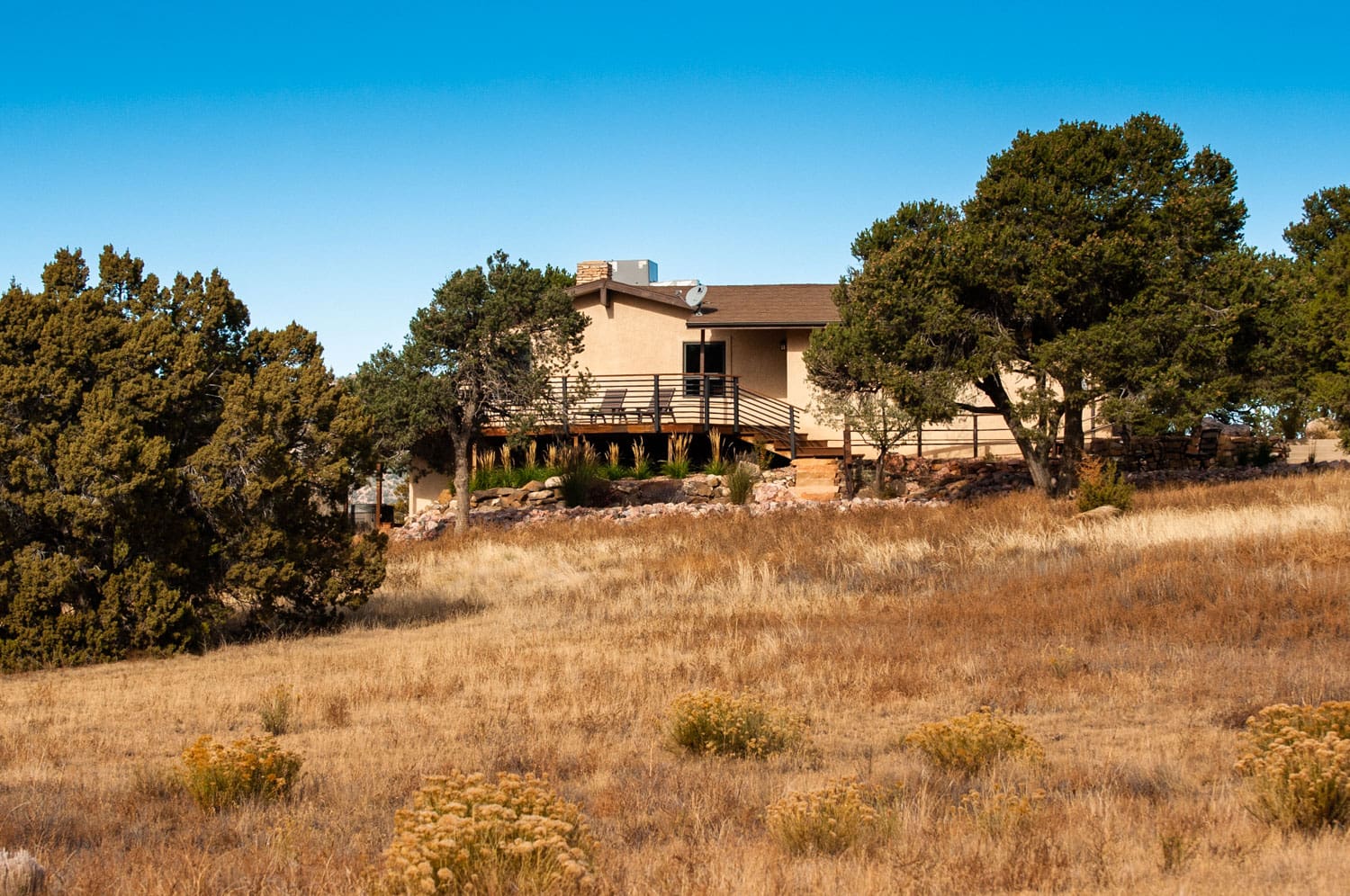 Pinon House tucked into native Pinon Trees and high desert prairie grass