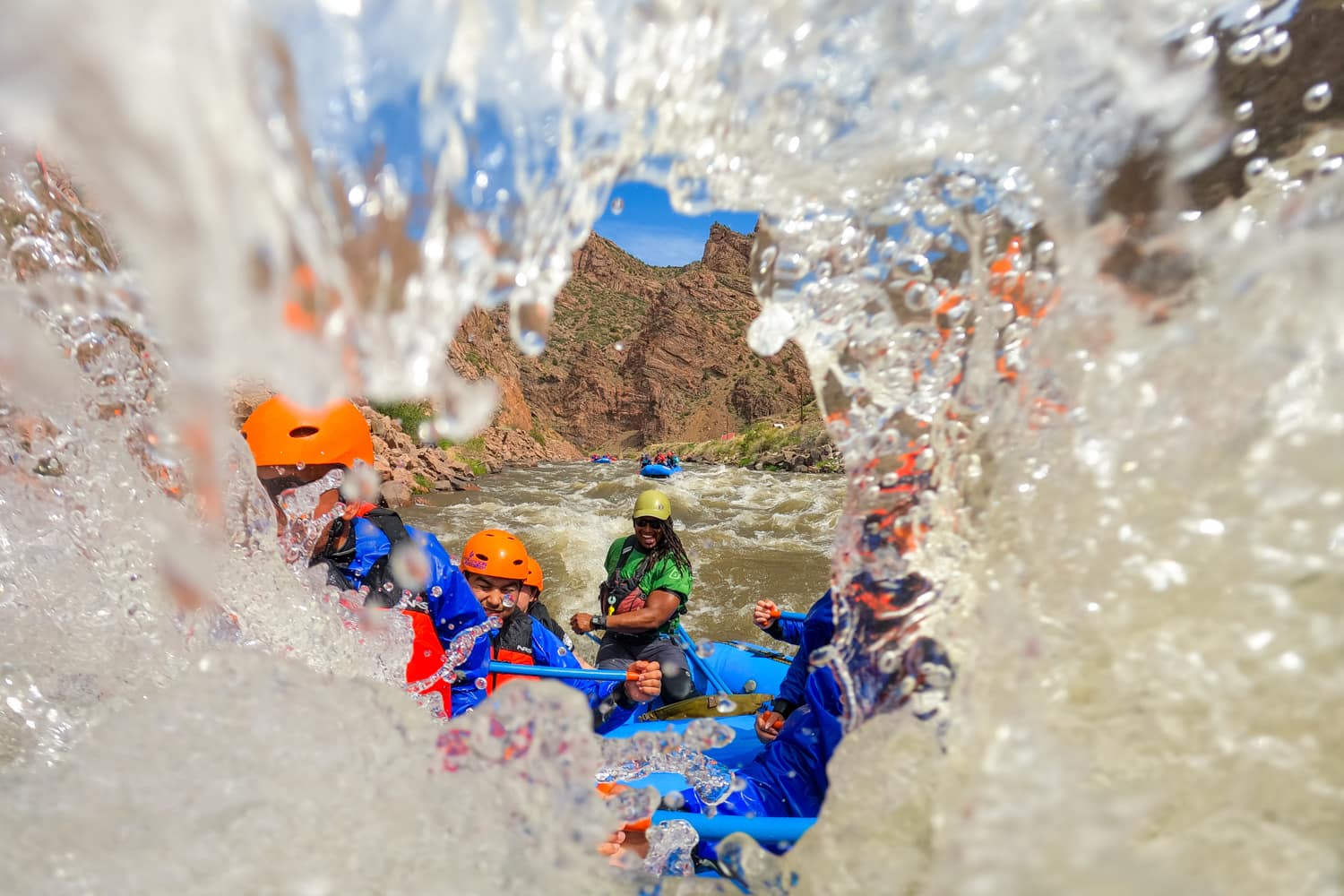 A group of adventurers white water rafting through Colorado rapids near Denver.