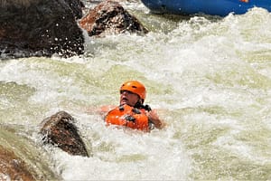rafter swimming in a rapid