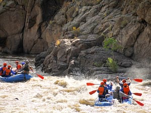 Rafting crews paddle into rapids in the Royal Gorge