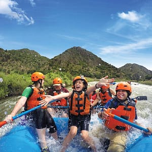 Family smiling together in a raft on Bighorn Sheep Canyon with Echo Canyon River Expeditions