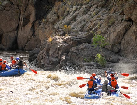 Rafting crews paddle into rapids in the Royal Gorge