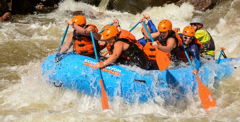 Rafters paddling through the Royal Gorge canyon on the Arkansas River, a popular day trip from Denver