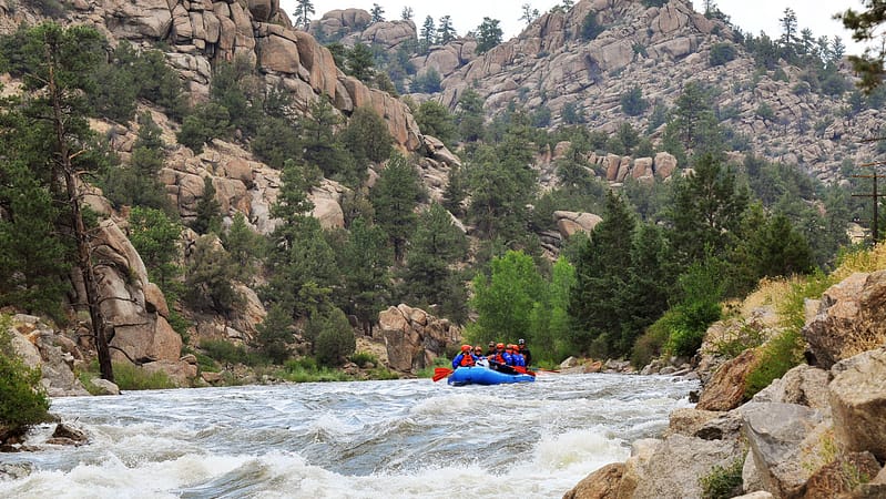 A group rafting down the scenic Arkansas River in Colorado.