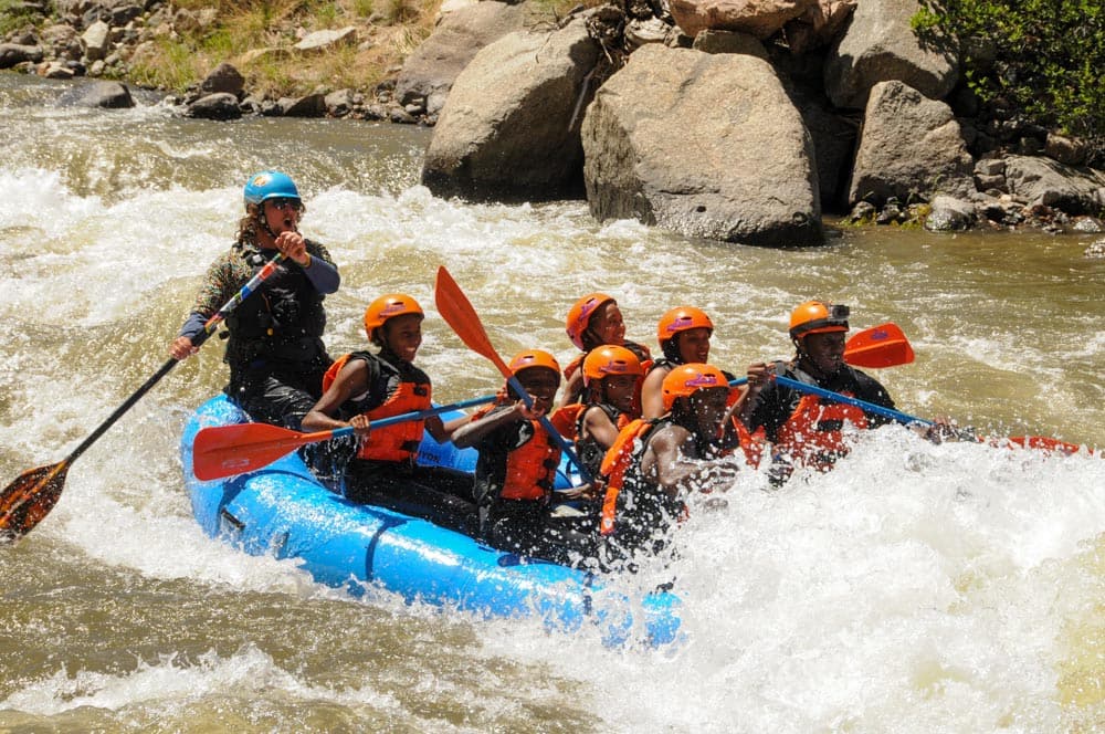 A pumped paddle crew heads into a big hit in Sharks Tooth Rapid