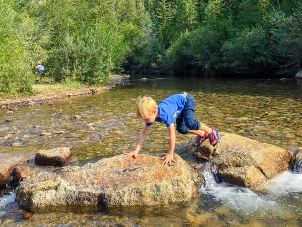 boy playing in Colorado creek